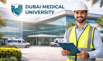 Dubai Medical University Hospital building with EHS safety officer holding clipboard outside modern healthcare facility UAE