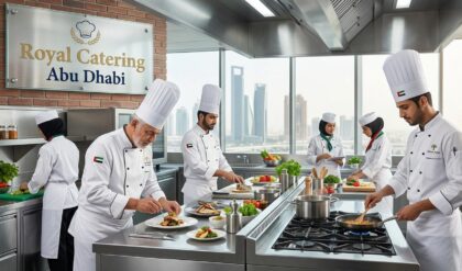 Professional chefs and hospitality staff working in a modern commercial catering kitchen during food preparation at Royal Catering Abu Dhabi.