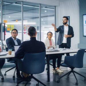 Marketing manager presenting charts on screen at team meeting best jobs with business degree e1788785981803